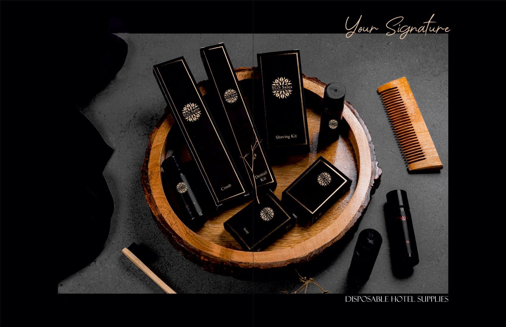 SGS custom-branded black and gold hotel amenity kits — comb, dental kit, shaving kit and soap boxes on a wooden tray